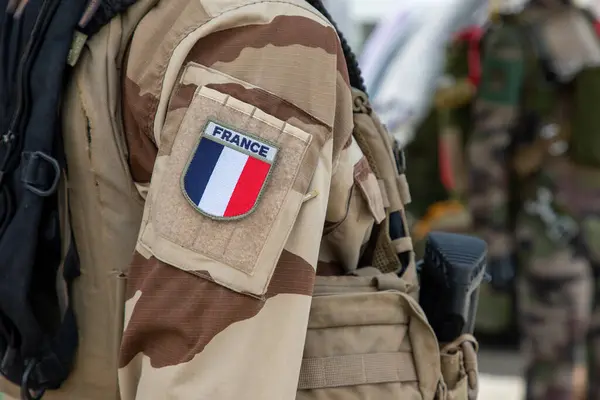 Stock image French logo text colors soldier in uniform during military parade