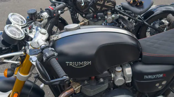 stock image Bordeaux , France -  07 08 2024 : Triumph thruxton neoretro motorcycle brand logo and text sign on fuel tank of British motorbike manufacturer