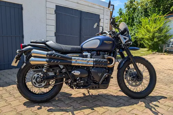 stock image La Rochelle , France - 08 06 2024 : Triumph scrambler street gold line new retro vintage logo sign and text on motorcycle silver blue fuel tank