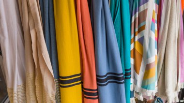 shop selling towels and beach bath robes in store exhibition of cotton towel for sale clipart