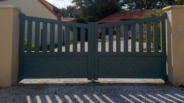 high dark grey home door aluminum gate gray slats portal garden of suburb house