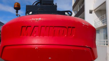 Bordeaux, France - 10 23 2024 : Manitou logo brand and text sign on nacelle 4 wheel drive forklift tractor Telescopic Handler industrial rent clipart