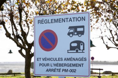 reglementation vehicule amenages pour l'hebergement french text means parking regulations for vehicles fitted out for accommodation with signage red blue round sign clipart