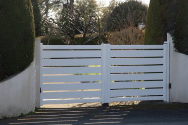 Aluminum modern white double gate home portal fence of suburb house entrance clipart