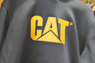Bordeaux, Fransa - 04 30 2025: kedi işaretli tırtıl ve moda dükkanındaki siyah sarı gömlekli marka metin bize ağır ekipman üreticisi olduğunu gösteriyor.
