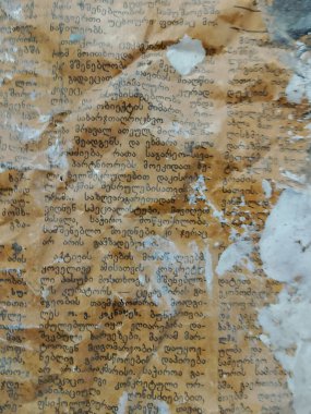 A grungy, aged parchment or paper surface covered in an ornate, indecipherable handwritten script or text, with stains, discoloration, and a mottled tan and blue-grey patina creating an antique, distressed texture backdrop. clipart