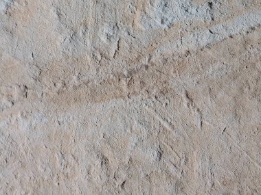 Bu resim, ince çizgilerinin doğal güzelliğini ve ince renk değişimlerini gösteren, toprak dokulu yüzeyin karmaşık detaylarını yakalar. Dengesiz arazide ışık ve gölgenin etkileşimi dinamik ama yatıştırıcı bir görsel efekt yaratır.