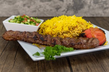 Slow roasted zeresch polo chicken with basmati rice and chopped fruit.