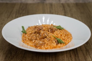 Italian risotto served with sausage and tomato sauce over a bed of rice. clipart