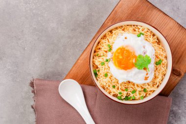 Makarna ya da domuz kıymalı ramen ve kaynamış yumurta fotokopi masasının üstünde.