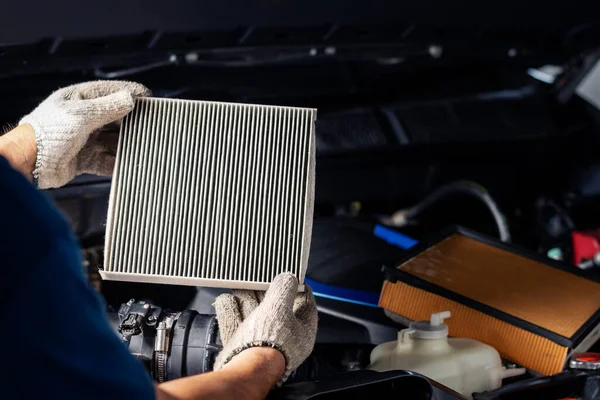 Repair and check car air conditioning system Technician holds car air filter to check cleanliness Clogging dirty or replacing the filter. Engine and transportation industry