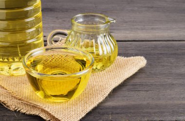 Bir kapta sebze yağı ve eski bir ahşap masanın üzerinde bir şişe sebze yağı vardı..