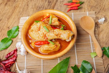 Körili tavuk Asya yemeği masalası. Geleneksel baharatlı sağlıklı yemek pişirme. Ahşap masa arkaplanına yerleştirilmiş.