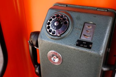 Swedish 1960s payphone inside an orange phone boot.