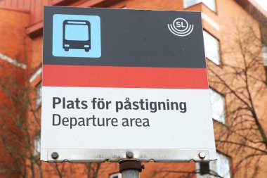 Stockholm, İsveç - 3 Mayıs 2023: Stockholm toplu taşımacılığı SL otobüs durağı tabelasında İsveççe ve İngilizce 'de iki dilde işaretli olarak belirtilmiştir..
