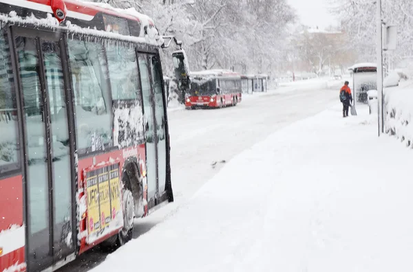 Sodertalje, İsveç - 3 Şubat 2019: Demiryolu istasyonunun yanındaki Lovisinsgatan sokağı, toplu taşıma otobüsleri ve otobüs duraklarının bulunduğu karla kaplı bir caddedir..