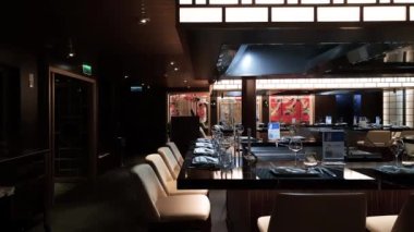 Ilha Bela, Sao Paulo, Brazil - December, 23, 2022:  Empty Japanese restaurant with low lighting inside a cruise ship.