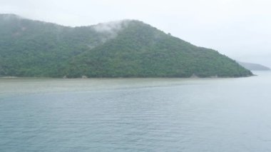 Ilha Grande (Big Island) in Rio de Janeiro, filmed from a cruise ship on a cloudy day_side tracking.