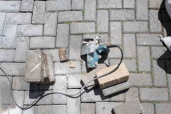 Small concrete saw next to stone blocks on a sunny day_top view.