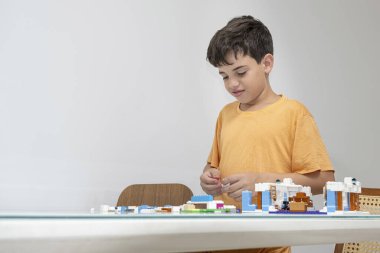 10 year old Brazilian child in pajamas, playing with building blocks_5.