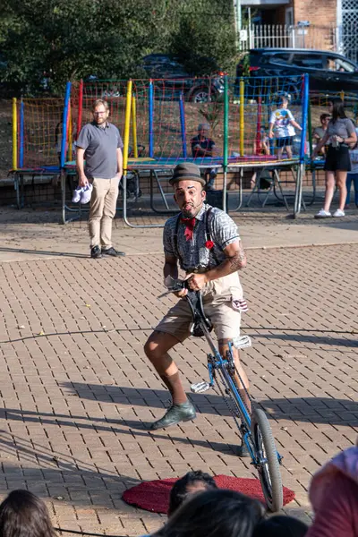 stock image SAO PAULO, SAO PAULO - BRAZIL, ON AUGUST 03, 2024: A street performer in suspenders performing in a public square_7.