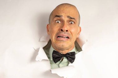 48 year old man in casual clothing and a bow tie, with only his head on a cardboard, showing emotions_8. clipart