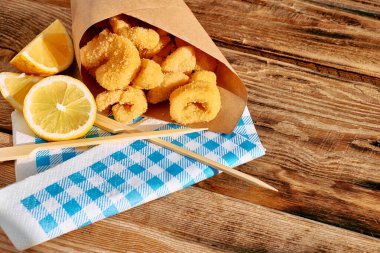 Typical Italian dish mixed deep fried seafood: shrimp, squid, octopus. Unhealthy food, fast food, street food.