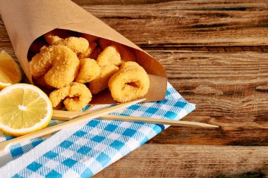 Typical Italian dish mixed deep fried seafood: shrimp, squid, octopus. Unhealthy food, fast food, street food.
