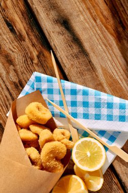 Typical Italian dish mixed deep fried seafood: shrimp, squid, octopus. Unhealthy food, fast food, street food.