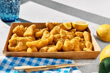 Typical Italian dish mixed deep fried seafood: shrimp, squid, octopus. Unhealthy food, fast food, street food.