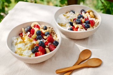 Çilekli, yaban mersinli ve beyaz kaseli hindistancevizli yoğurt taneciği. Sağlıklı kahvaltı, vejetaryen yemeği, diyet, kilo kaybı, sağlıklı beslenme.