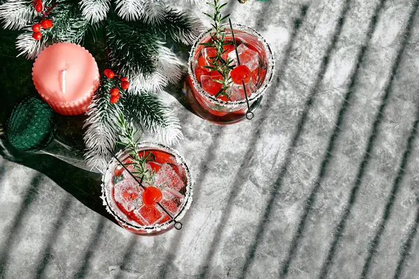 Christmas cranberry cocktail. Delicious icy alcoholic drink with berries and ice. Festive mocktail for winter holidays.