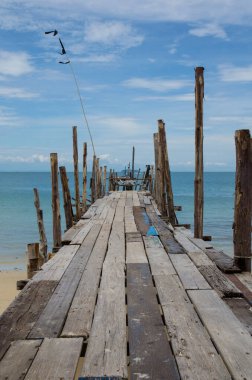 old bridge on beach and sea