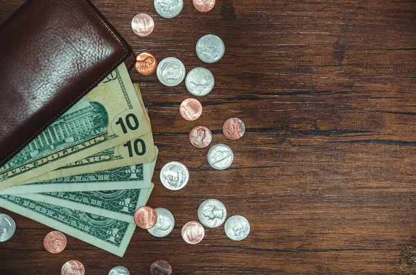 dollar bill with coin on pocket on top view