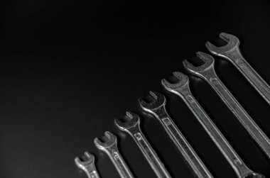 sort of silver wrench on black background