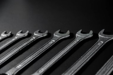 sort of silver wrench on black background in side view