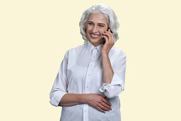 Portrait Happy Smiling Aged Woman Talking Phone Isolated Pastel Yellow — Stock Photo, Image