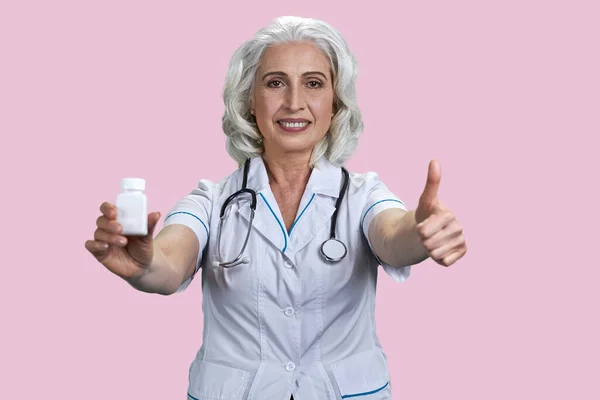 Portrait Happy Aged Female Doctor Shows Medicine Bottle Thumb Advertising — Stock Photo, Image