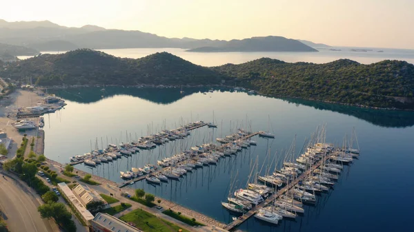 stock image Aerial view of sea bay with parked boats, embankment, mountains and city street. Beautiful landscape view of Kas town, Turkey.