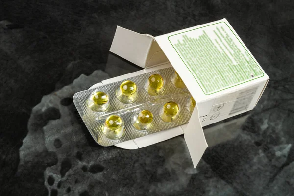 Blister of round yellow pills in a pack. Medical treatment concept.
