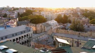 Aerial drone view of Odessa city at sunset or sunrise. Urban scape with buildings roofs.