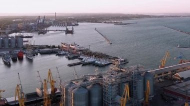 Odesa, Ukraine - 08.08.2020: Aerial drone view of Odessa sea port infrastructure. Tower cranes and ships.
