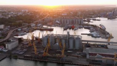 Aerial drone view of cityscape of sea port infrastructure. Evening sunset light.
