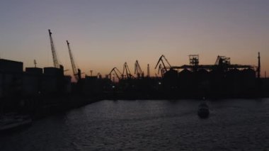 Sea port and a ship with no lights at night. Blackout in Odessa, Ukraine.