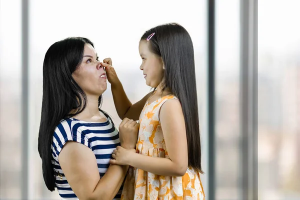 Little Girl Making Pig Nose Her Mother Having Fun Fooling — Stock Photo, Image