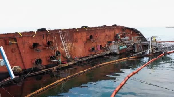 Old Rusty Overturned Oil Tanker Lying Its Edge Shallow Water — Stockvideo
