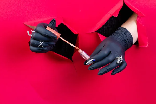 Hands Black Gloves Holding Lip Gloss Stick Breaking Red Paper — Stock Photo, Image