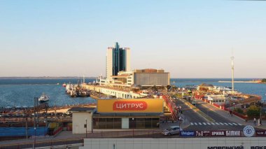 Odesa, Ukraine - 08.08.2020: Hotel Odessa and the cruise ship terminal at Odesa port. Evening urban scape background.