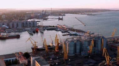 Aerial drone view of Odessa sea port infrastructure. Tower cranes and ships.