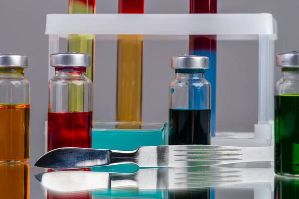 Collection Drug Vials Colored Solution Sharp Mettalic Knife Scientific Lab — Stock Photo, Image